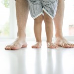 child and parent feet on floor