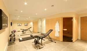 A titled residential basement gym and sauna.