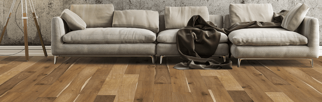 Beige couch on multi-tone plank flooring