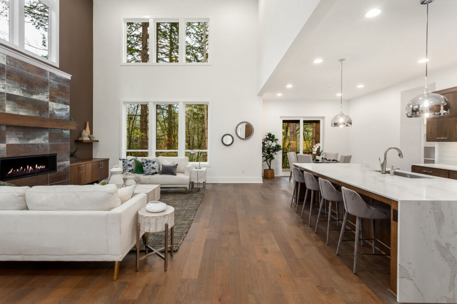 Open concept kitchen and living room with wide plank hardwood