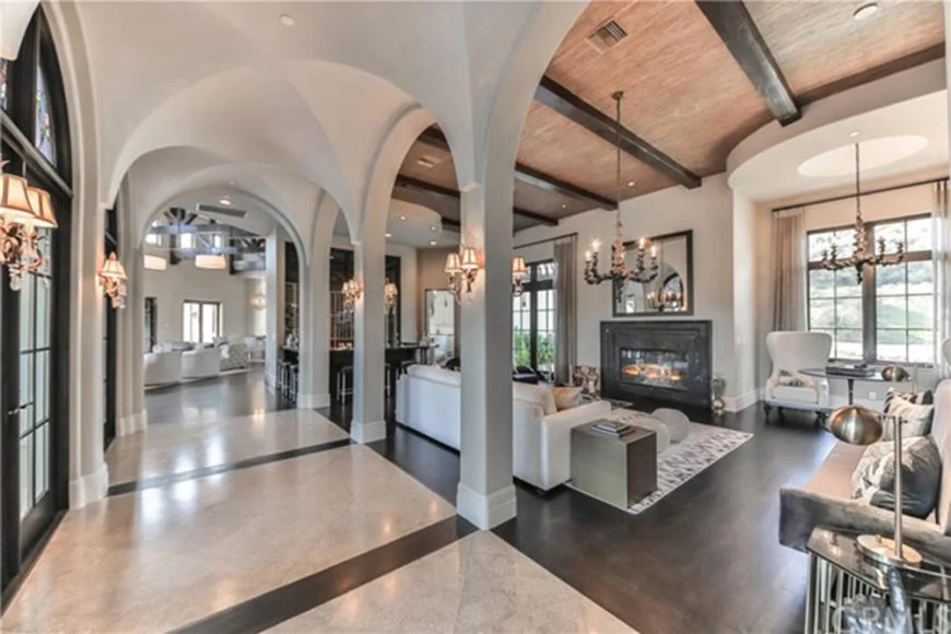 Britney Spear's living room with both white tile and dark hardwood flooring