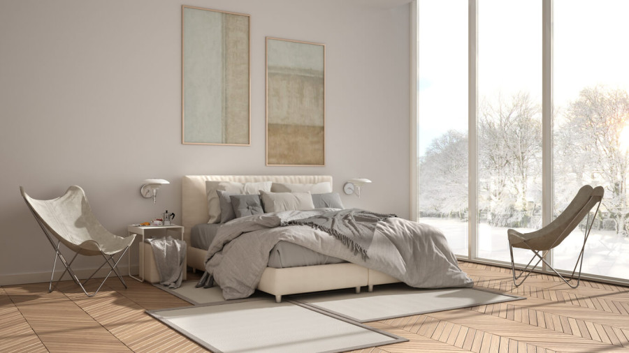A bedroom with herringbone wood flooring